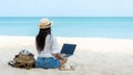 Lifestyle freelance woman using laptop working and relax on the beach.ÃÂ 